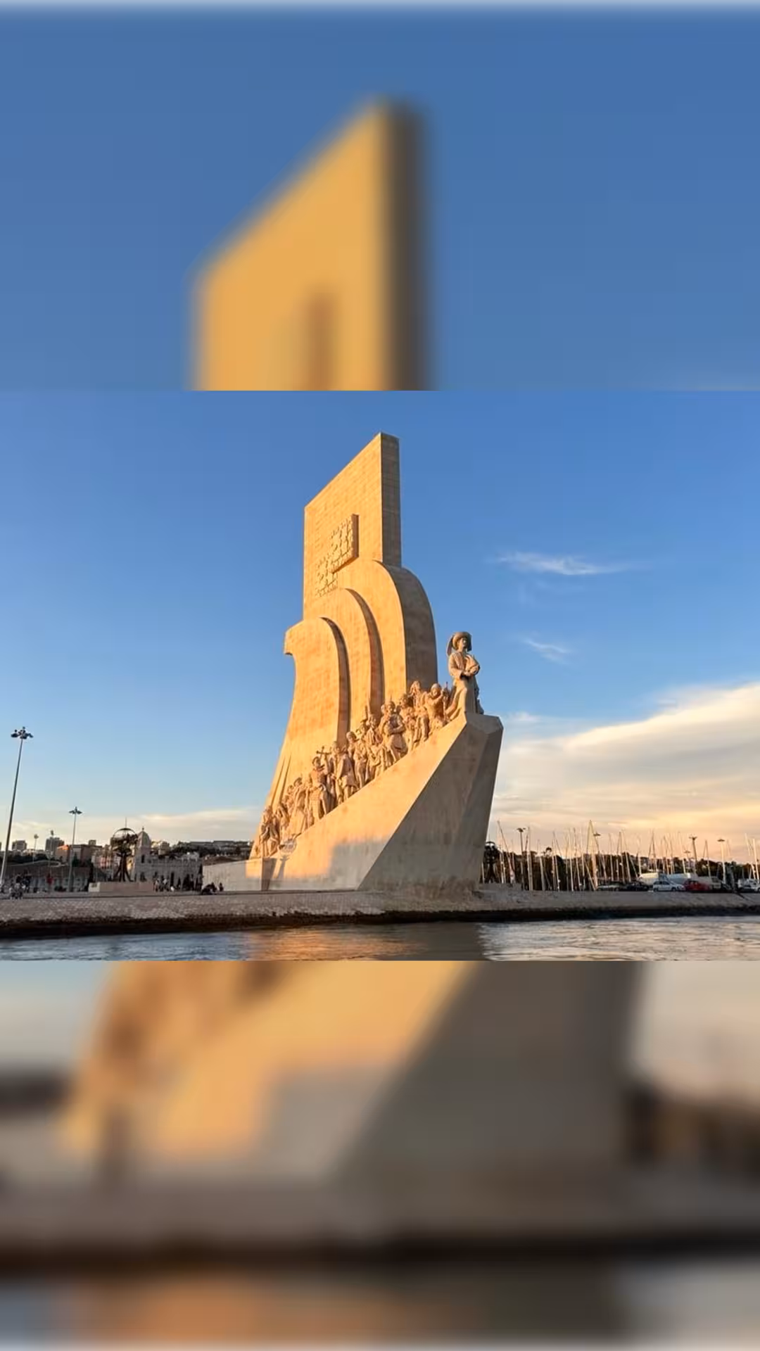 Padrão dos Descobrimentos monument at golden hour seen from a Lisbon sunset boat tour on the Tagus River
