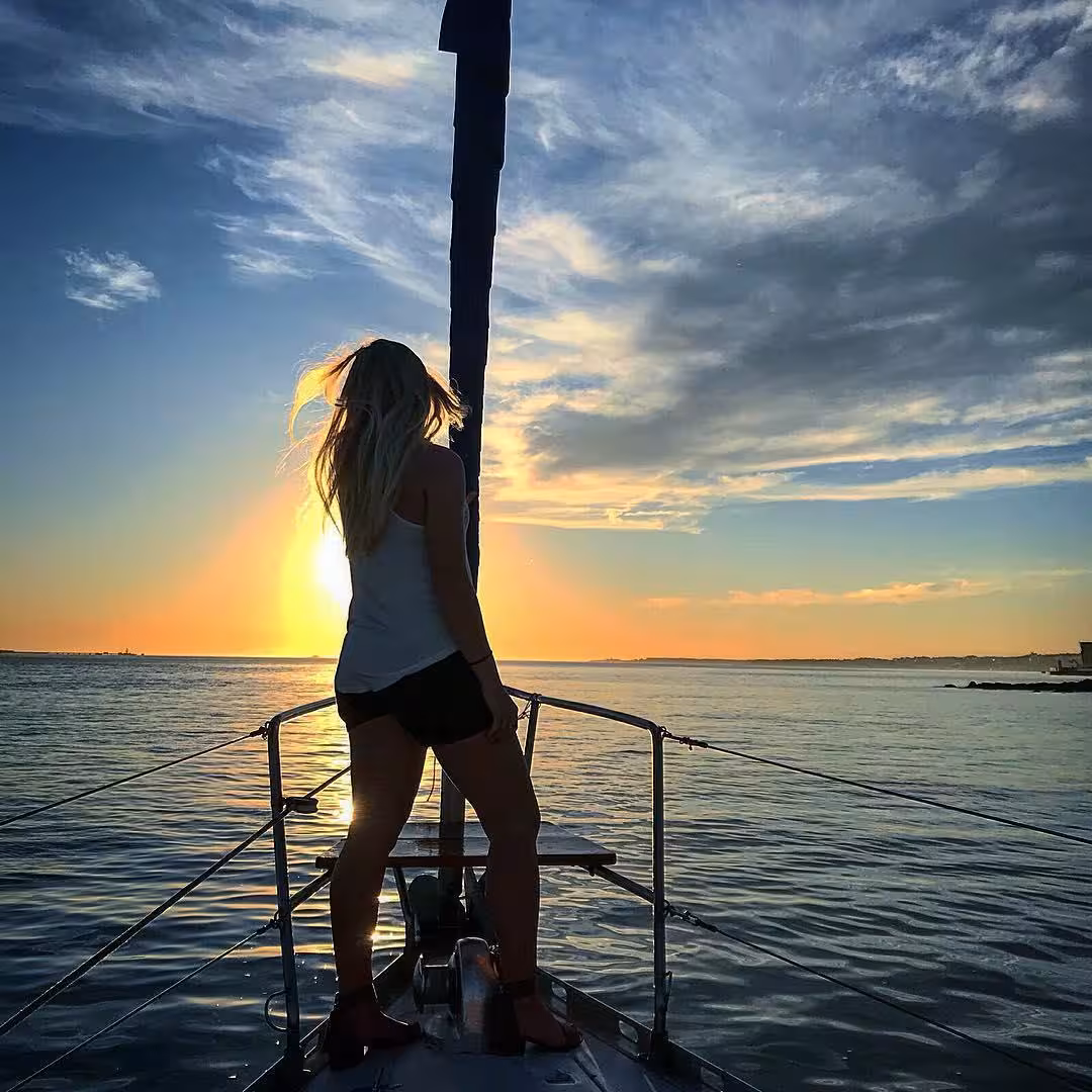 Silhouette on boat bow at sunset in Lisbon, Tagus River cruise with wine tasting ticket experience