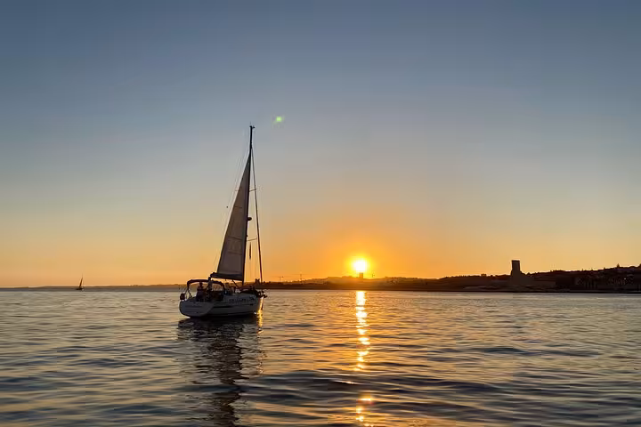 Sailboat on Tagus River at golden hour on a Lisbon romantic private 2h sunset cruise with sparkling wine