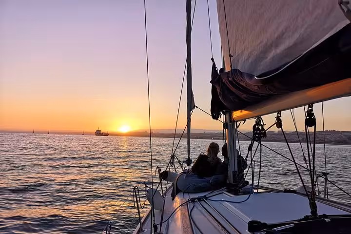 Sailboat cruising at golden hour in Lisbon on 2-hour small-group sunset sailing tour with drink included