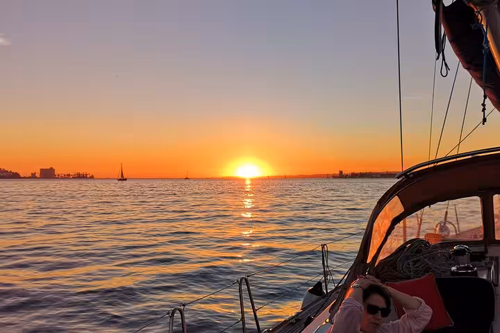 Lisbon sunset sailing on a luxury yacht on the Tagus River, golden horizon views with 2 drinks included