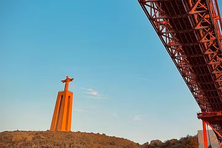 Cristo Rei and 25 de Abril Bridge at golden hour, Lisbon sunset sailing tour on the Tagus River