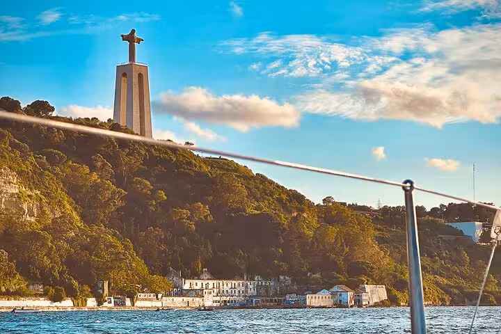 Sunset sailing in Lisbon past Cristo Rei statue on the Tagus River, scenic 2-hour boat cruise view