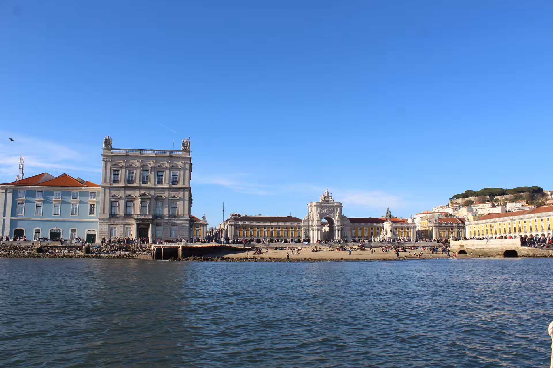 Lisbon sunset speedboat tour view of Praça do Comércio and Rua Augusta Arch from the Tagus River waterfront