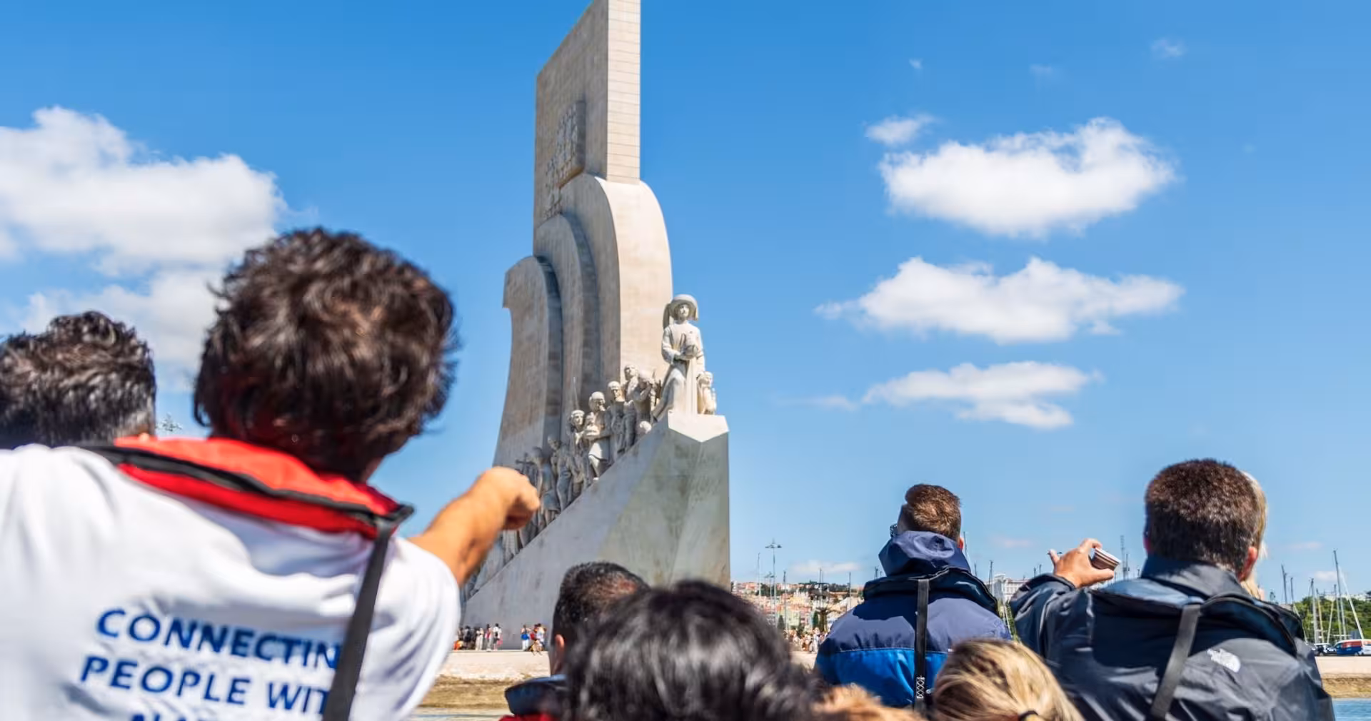 Passengers spot the Monument to the Discoveries on a Lisbon sunset speedboat tour along the Tagus River