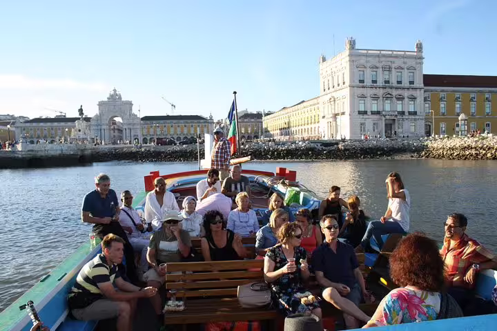 Relax on a Lisbon express cruise as passengers enjoy views of the iconic Praça do Comércio from a traditional boat.