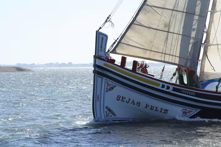 Traditional Lisbon sailing boat 'Sejas Feliz' gliding on the Tagus River, showcasing authentic Portuguese craftsmanship.
