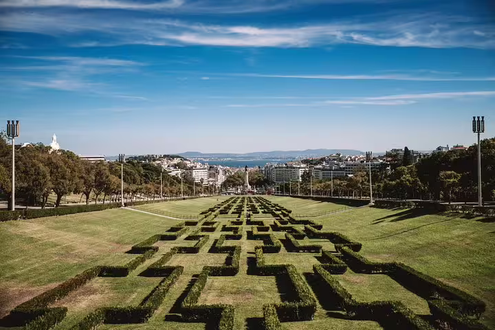 Panoramic view of Lisbon's Eduardo VII Park with geometric hedges, a highlight on the 4-hour private tuk tuk tour.