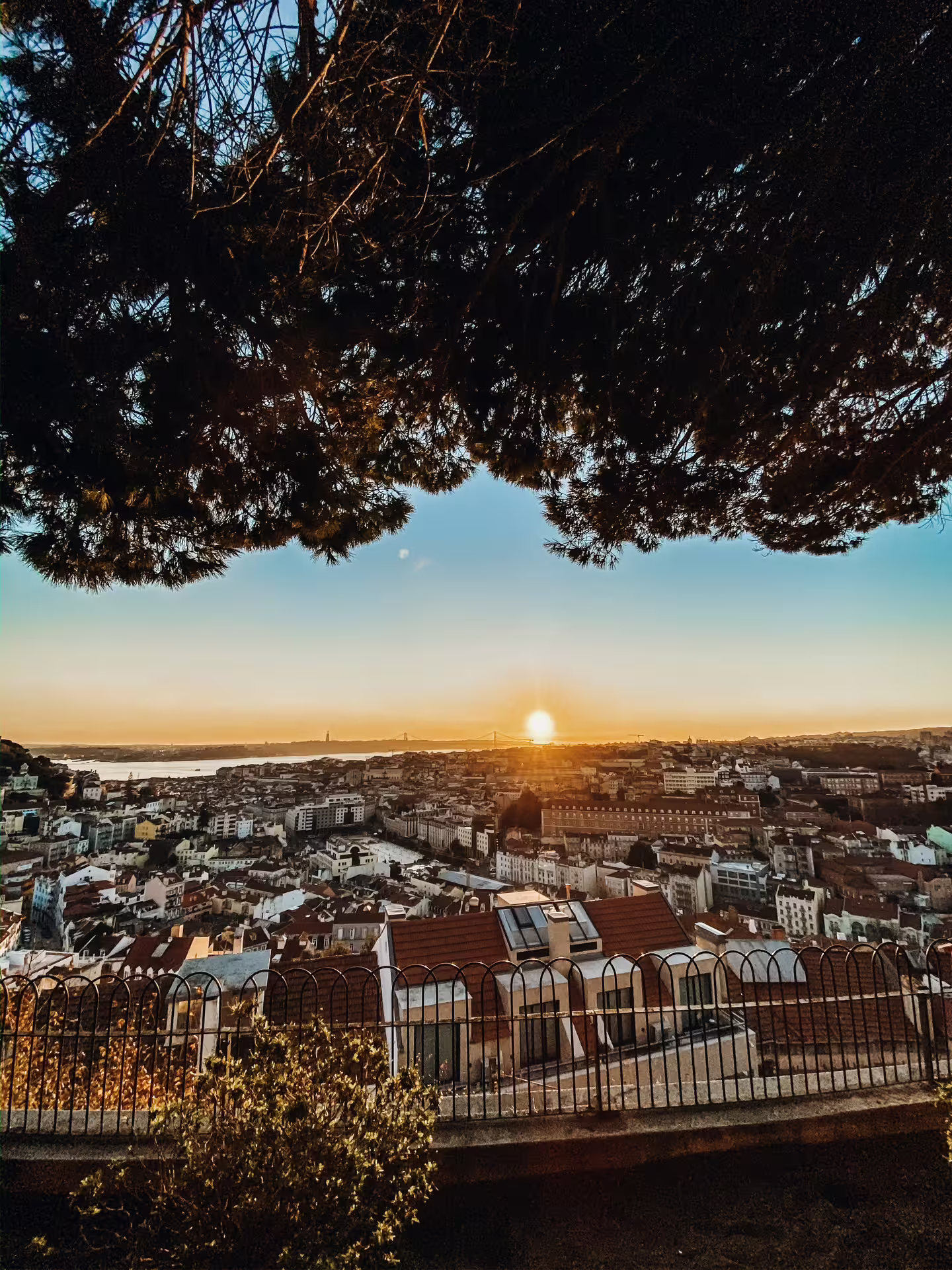 Breathtaking panoramic view of Lisbon at sunset, showcasing the city's historical architecture and vibrant skyline.