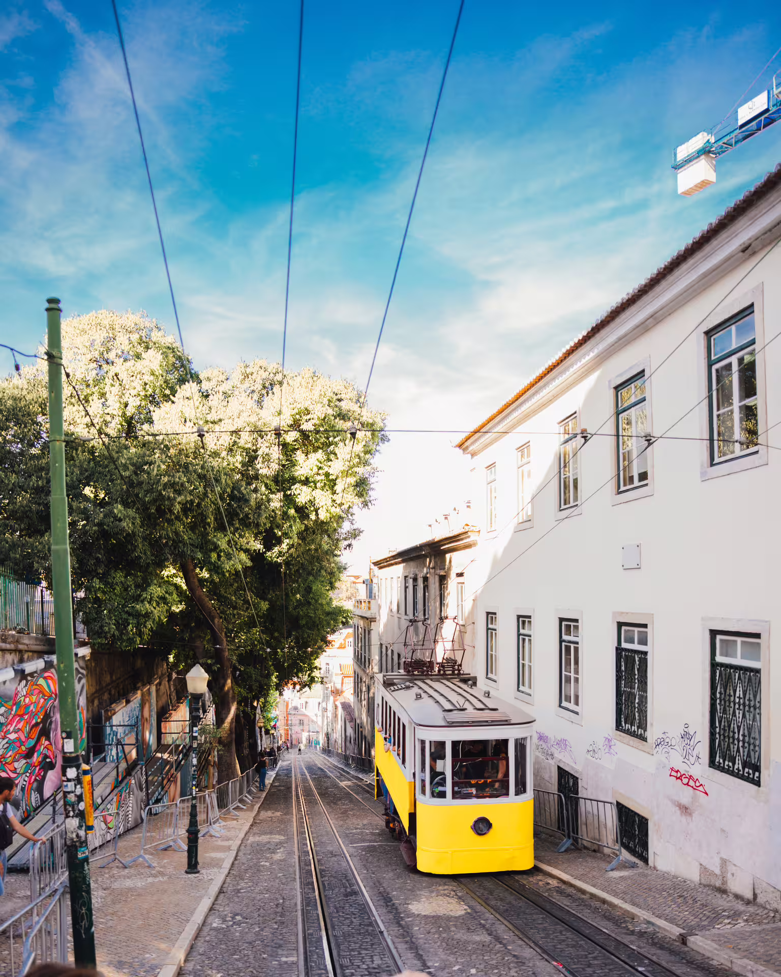 Experience Lisbon's charm riding a classic yellow tram on a Tuktuk tour, exploring vibrant streets and culture.