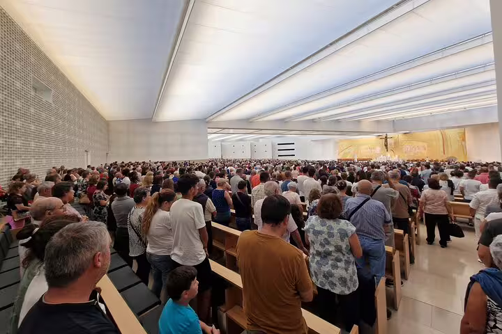A large crowd gathers inside a modern church near Lisbon, Portugal, highlighting the cultural depth of the 3-day World Heritage tour.