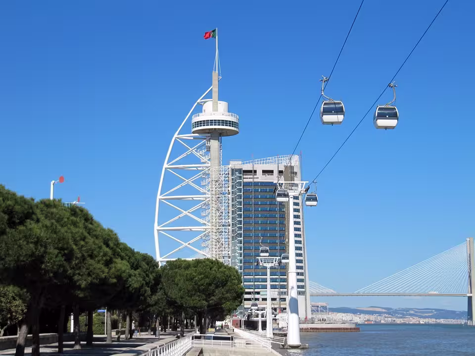 Lisbon's Vasco da Gama Tower and cable cars on a sunny day, offering breathtaking views on a family tour.