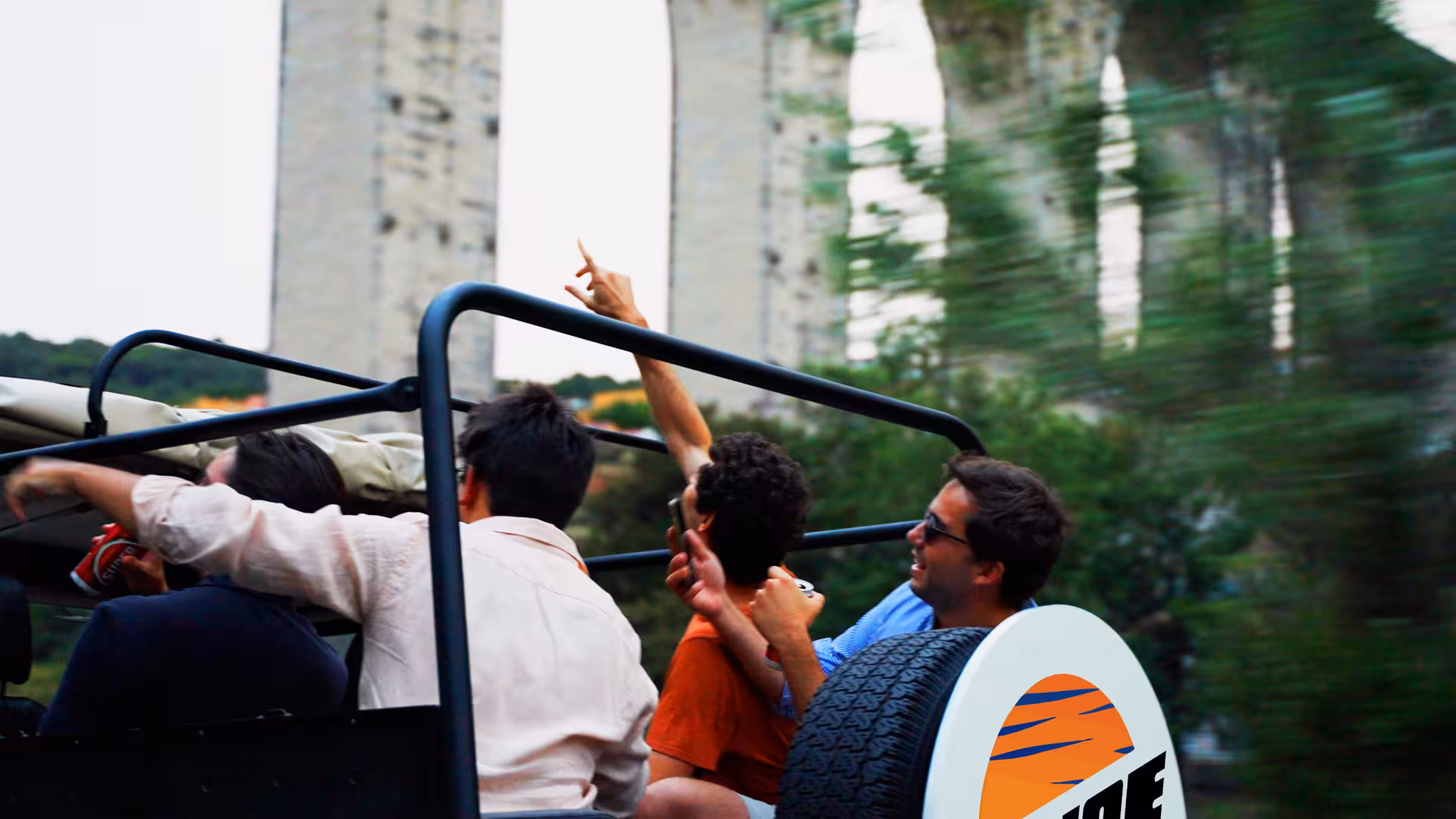 Guests riding a vintage Jeep on a Lisbon daily tour, enjoying city views with food and drink tastings