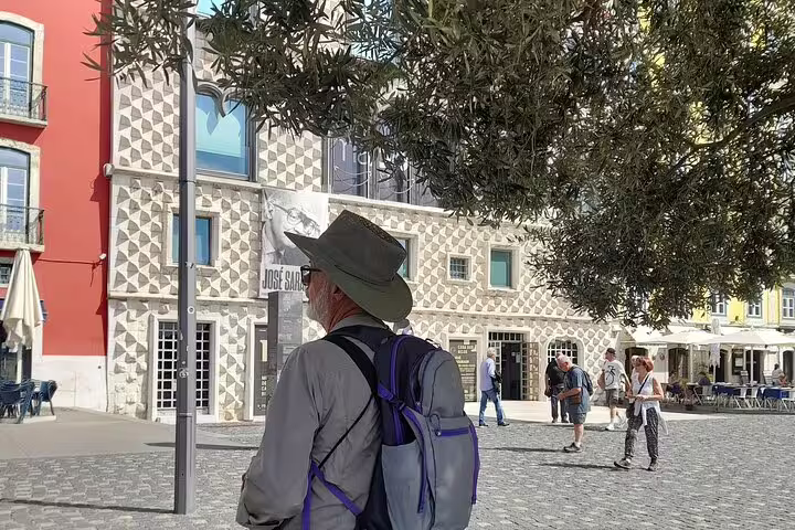 Tourist exploring Lisbon's unique architecture on a walking tour, featuring vibrant buildings and cobblestone streets.
