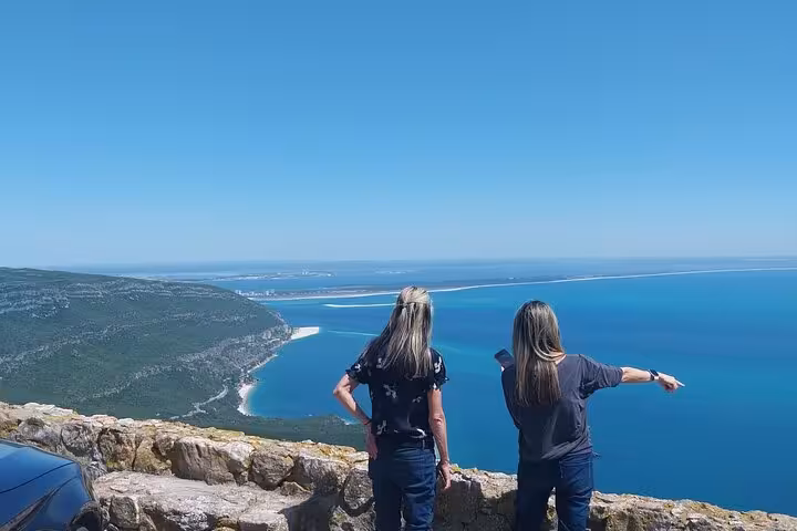 Arrábida panoramic viewpoint on Lisbon wine and food tour, guests overlooking blue ocean and coastline