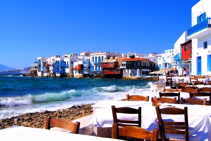 Little Venice Mykonos waterfront with seaside restaurants and waves, seen on an Athens to Mykonos day trip