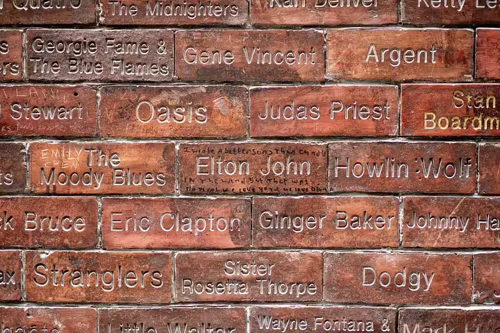 Liverpool music heritage wall with engraved bricks honoring artists like Elton John, Eric Clapton, and Oasis