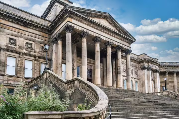 Grand neoclassical building with tall columns and sweeping stone staircase in Liverpool city centre
