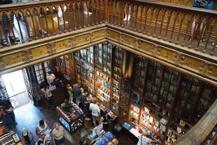 Tourists explore the historic Livraria Lello bookstore in Porto, a highlight of the private day trip from Lisbon.
