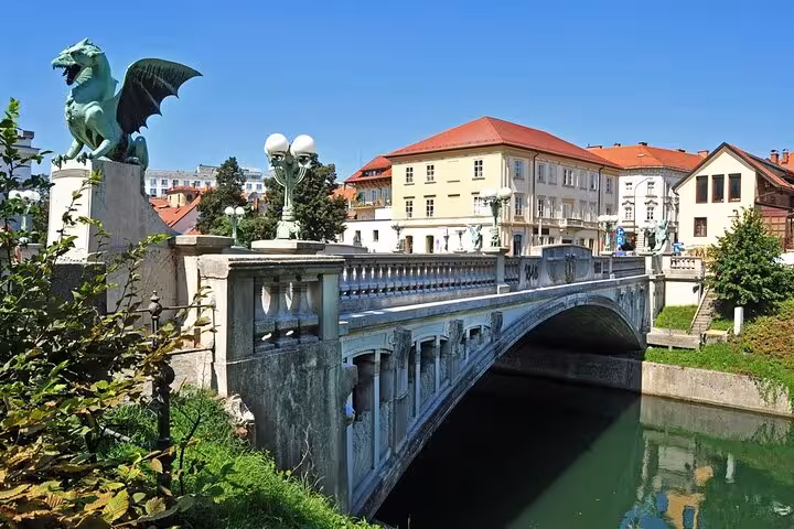 Ljubljana Dragon Bridge over the Ljubljanica River, highlight of a private day trip from Vienna