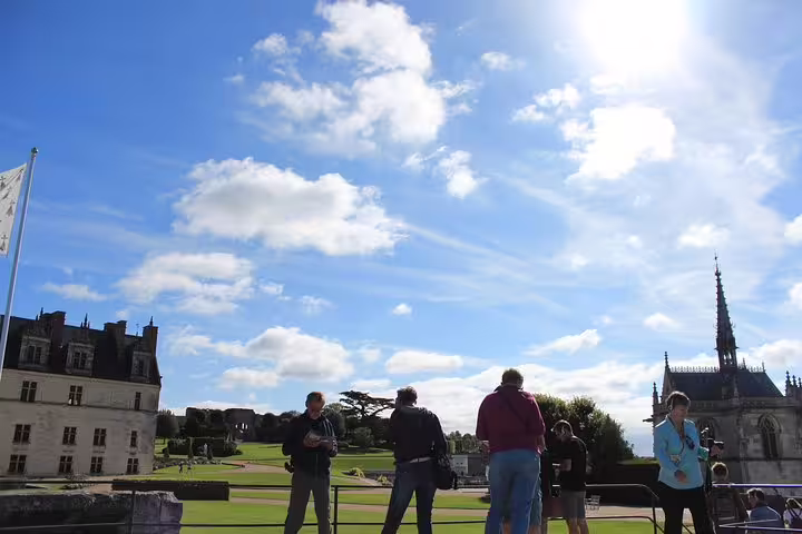 Loire Valley castle visit with tour guests enjoying panoramic château gardens on a sunny wine tasting day trip