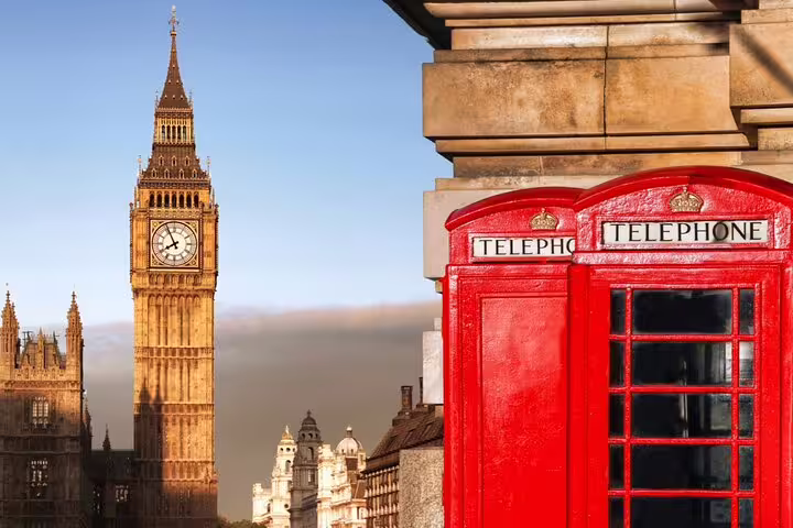 Red telephone boxes with Big Ben and Houses of Parliament in London on a clear day
