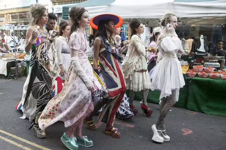 Fashionably dressed group explores vibrant Camden Town market during a London Unexpected Private Tour, highlighting street art and unique style.