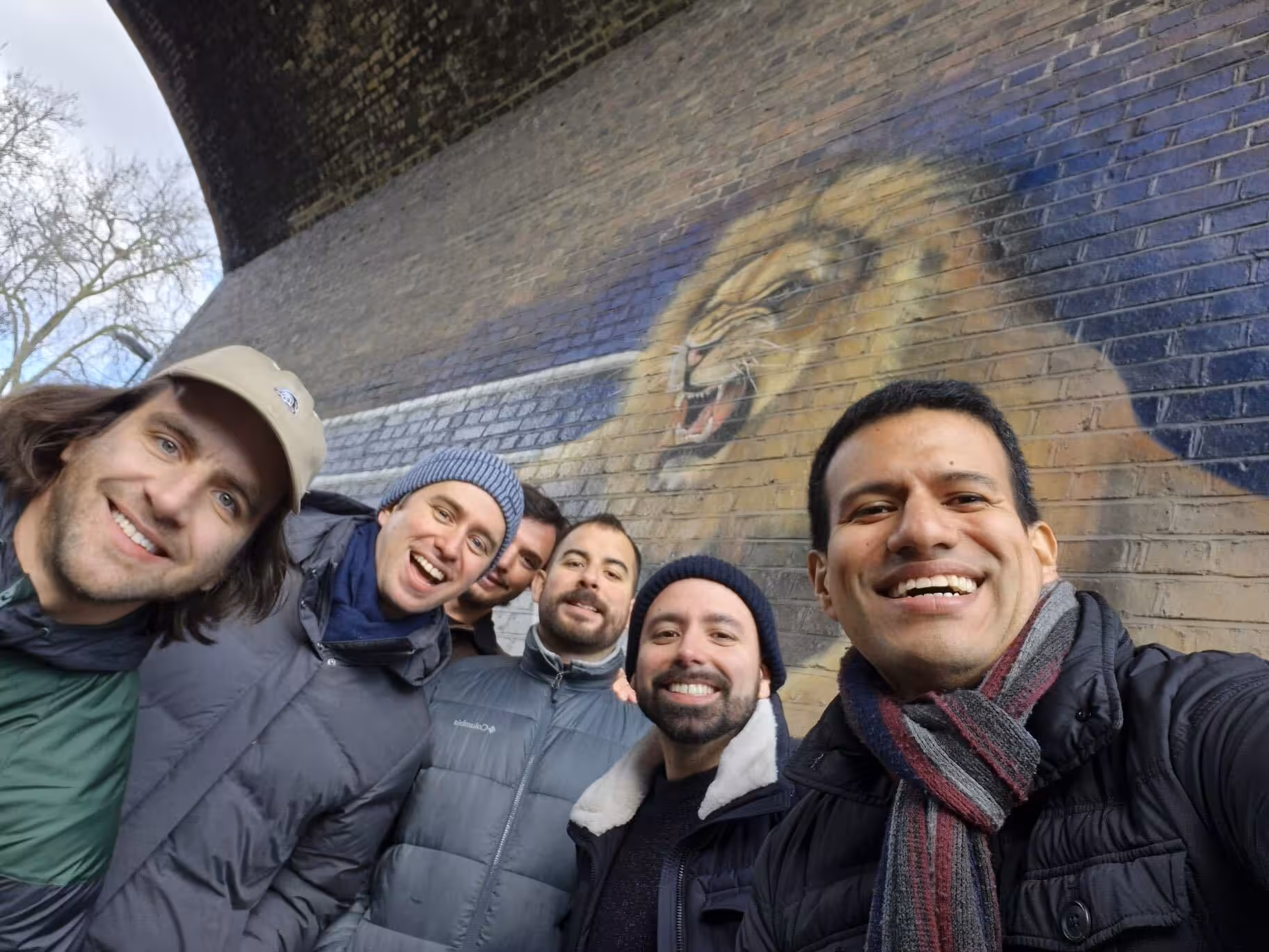Group selfie with local host by London lion mural, pre-match football experience tour with a local fan
