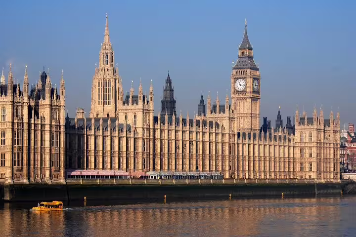 The iconic Houses of Parliament and Big Ben in London viewed from the Thames, ideal for a private layover tour.
