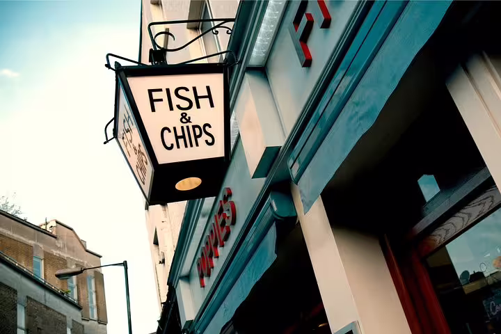 Traditional London pub with iconic Fish & Chips sign, showcasing authentic British food experience on private tavern tour.