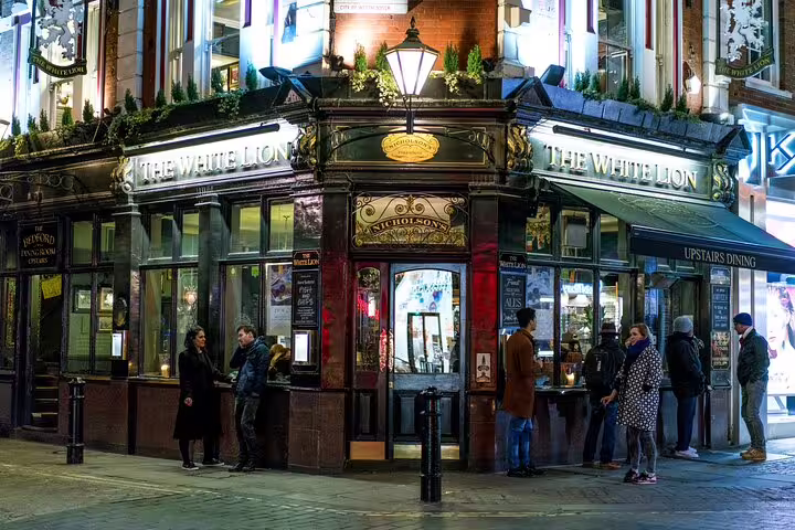 Historic London pub with people outside, perfect for a private food and drinks tour exploring British taverns and culture.