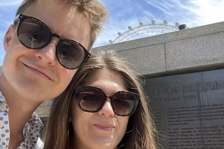 Couple taking selfie near London Eye and Battle of Britain memorial on South Bank