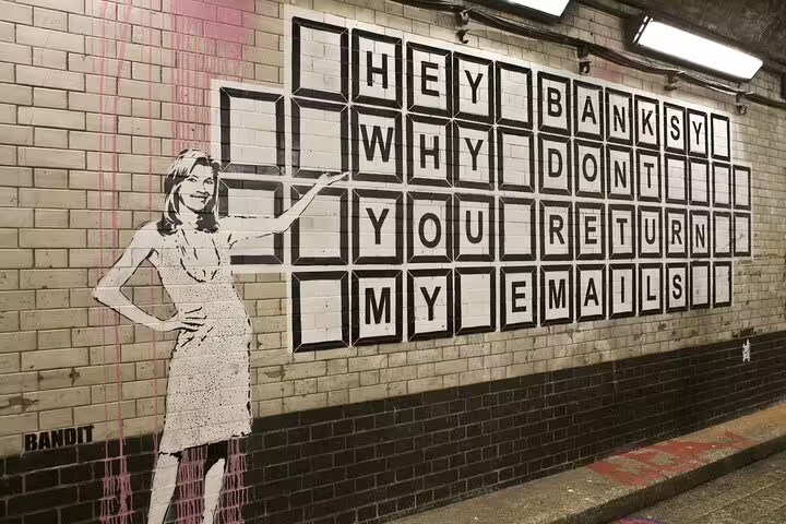 Street art in London featuring a mural with humorous text, part of a vibrant stop on a private bike tour with lunch.