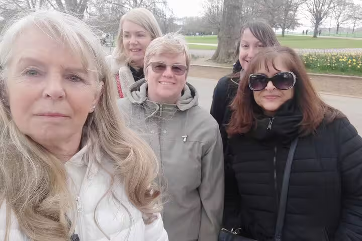 Group of five women taking a selfie outdoors in a London park during a walking tour