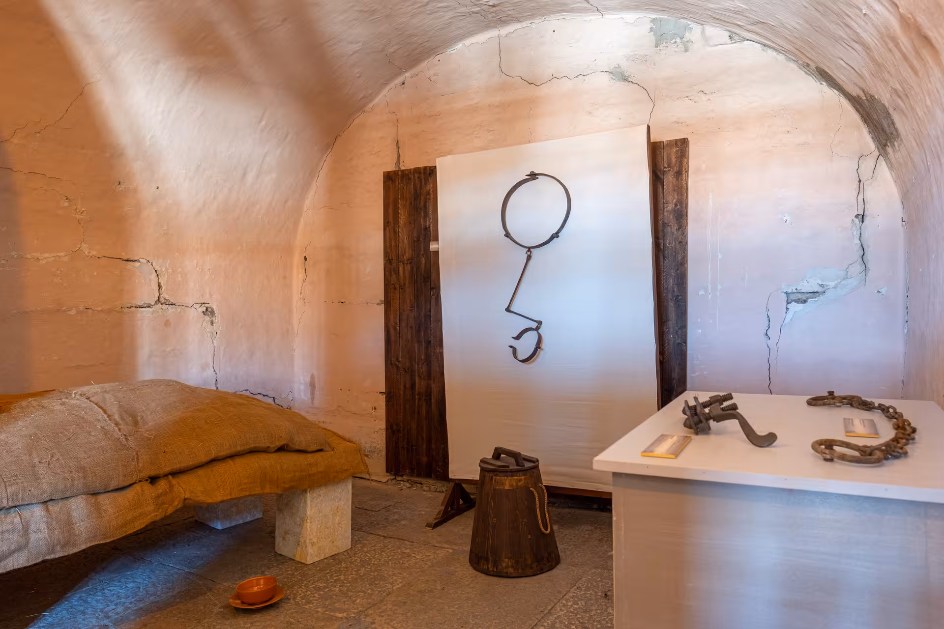 Historical cell with torture tools and rustic bedding in Lords of The Night Prison Palace visit.