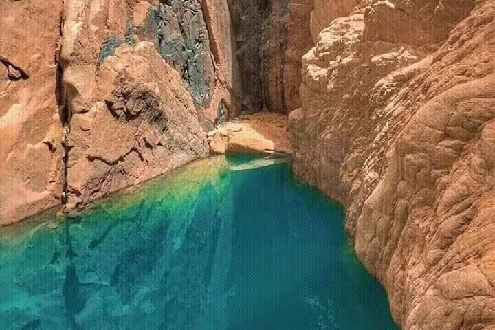 Crystal-clear Lost Lake pool between Sinai sandstone cliffs, highlight of Sharm El Sheikh private Jeep safari to Dahab