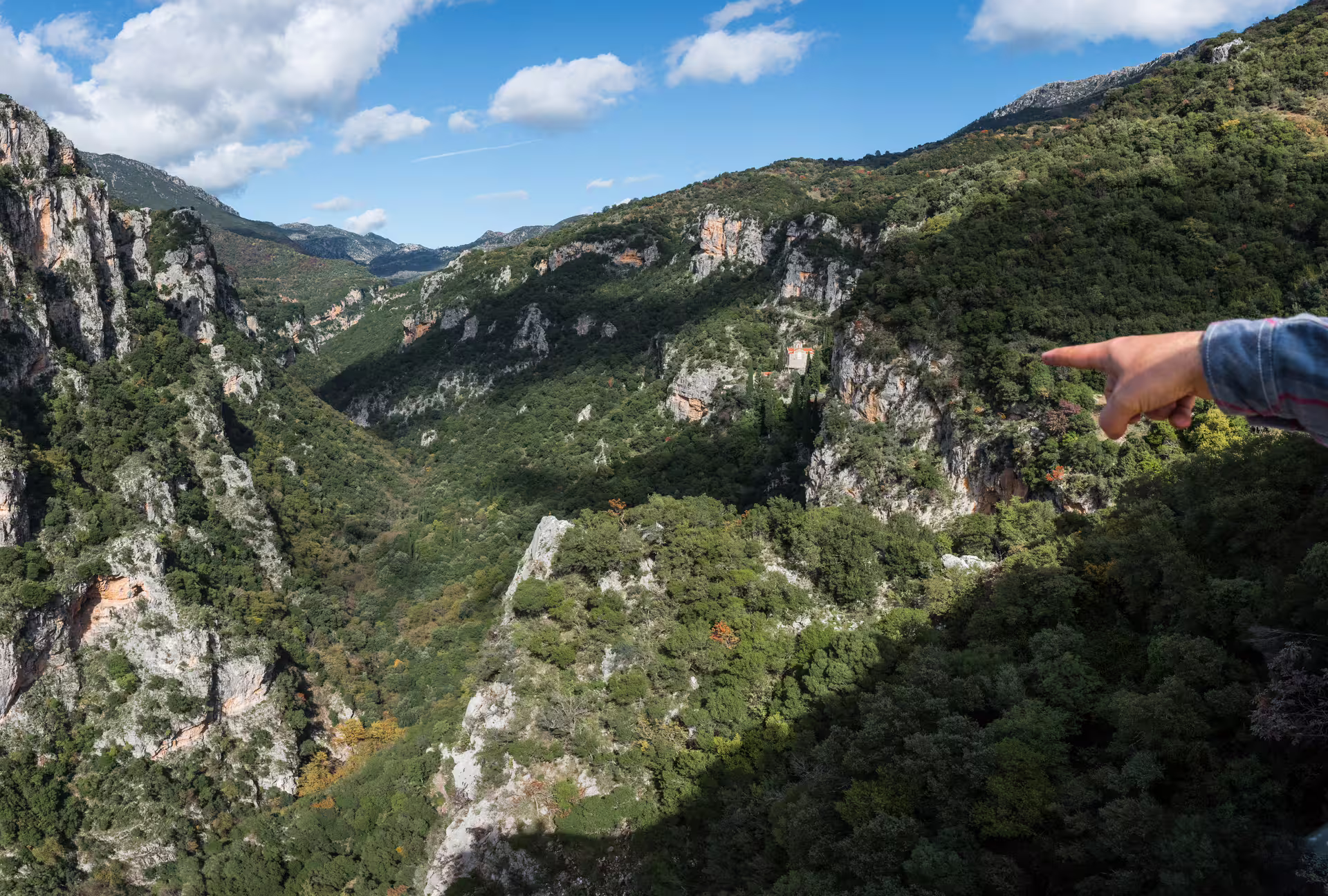 Panoramic Lousios Gorge hike viewpoint in Arcadia, Peloponnese Greece, with cliffs, forest and monastery