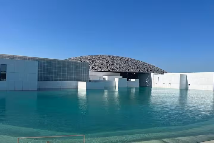 Louvre Abu Dhabi dome and reflecting pool stop on a private Abu Dhabi city tour with Grand Mosque entrance