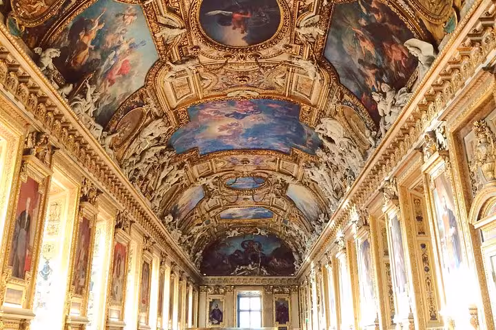 Ornate gilded ceiling with baroque paintings in the Louvre's Apollo Gallery, Paris