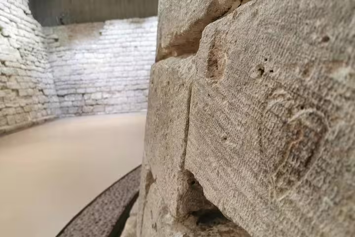 Close-up of medieval stonework inside the Louvre on a guided skip-the-line museum tour in Paris