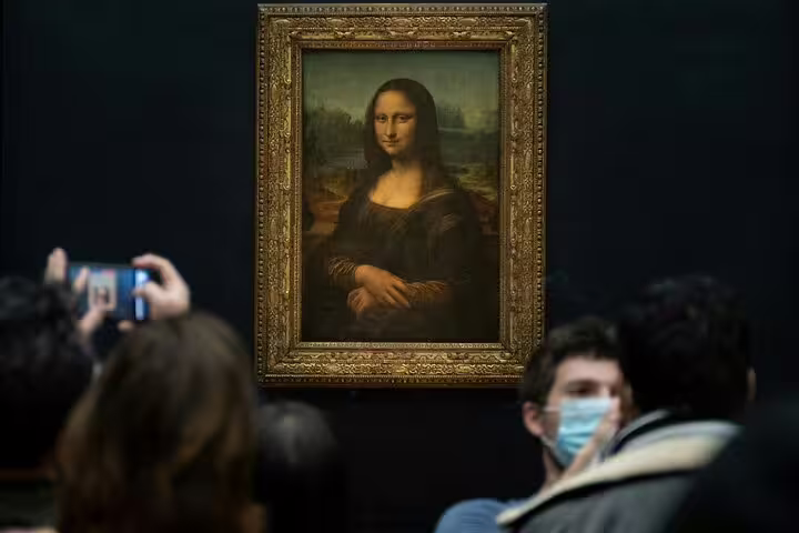 Crowd gathers around the iconic Mona Lisa at the Louvre, capturing the essence of Parisian art tours and experiences.