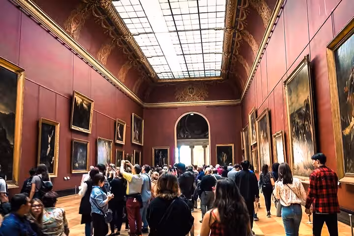 Louvre Museum grand gallery packed with visitors on a private guided Paris tour before Seine River cruise and lunch