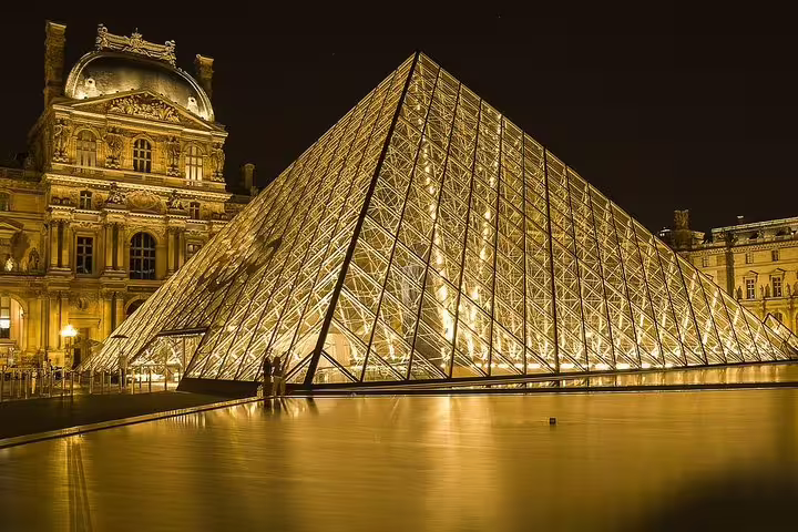 Louvre Pyramid illuminated at night, highlight stop on a private Paris by night sightseeing tour with driver