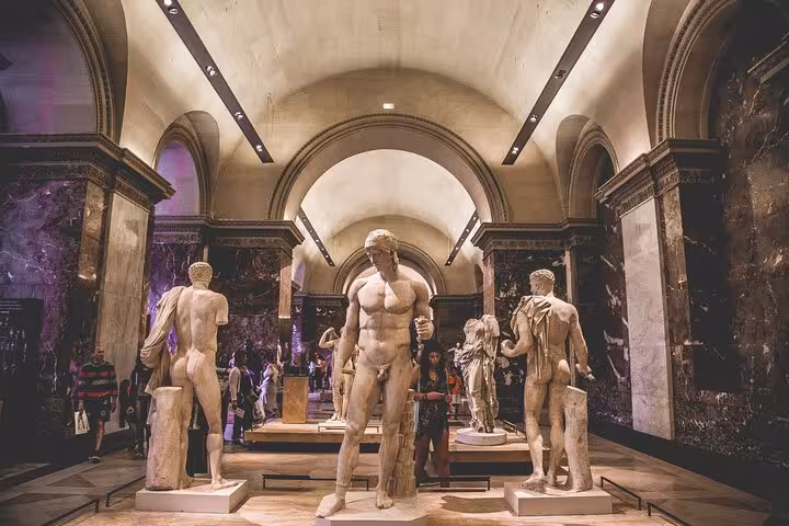 Classical sculptures in the Louvre museum gallery, skip-the-line access with Full Day Paris City Pass