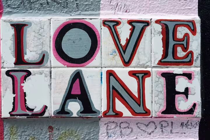 Colorful tiled Love Lane street sign with red, pink, and grey lettering in Dublin