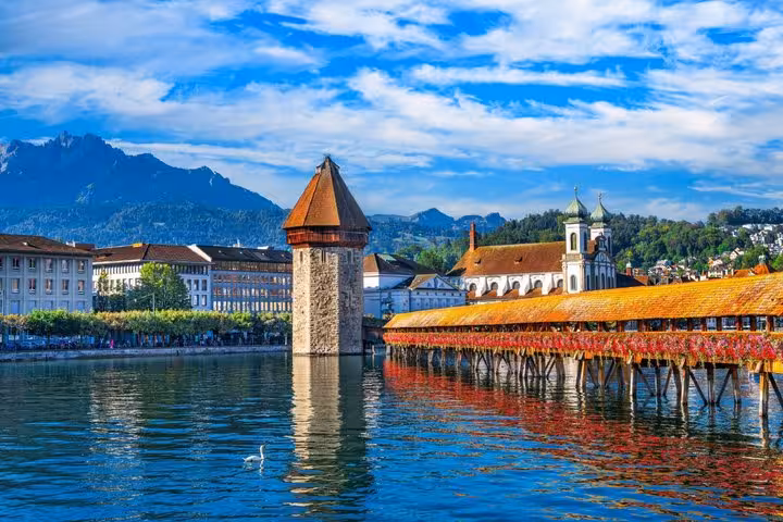 Chapel Bridge and Water Tower over Lake Lucerne with Alps in background, Switzerland