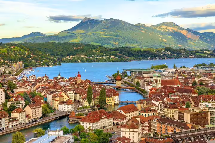 Panoramic view of Lucerne's charming architecture with Mount Rigi and Lake Lucerne in the distance.