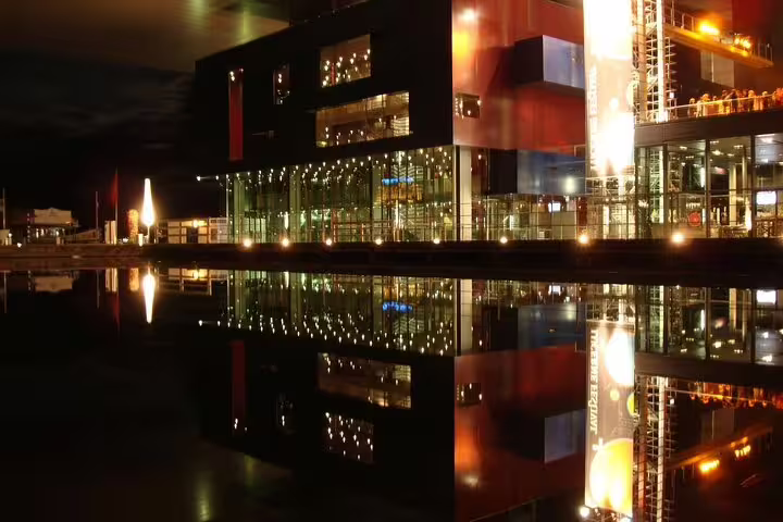 Lucerne waterfront buildings illuminated at night reflecting on calm water