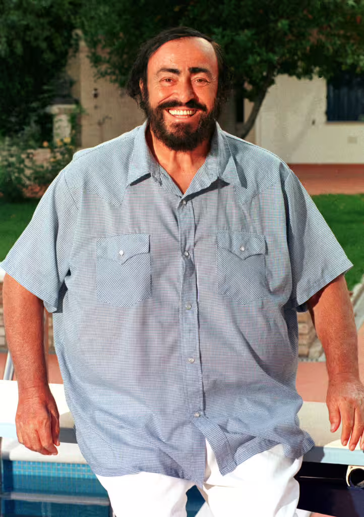 Luciano Pavarotti smiling outdoors at his Modena home, promoted with entrance ticket to Pavarotti House Museum