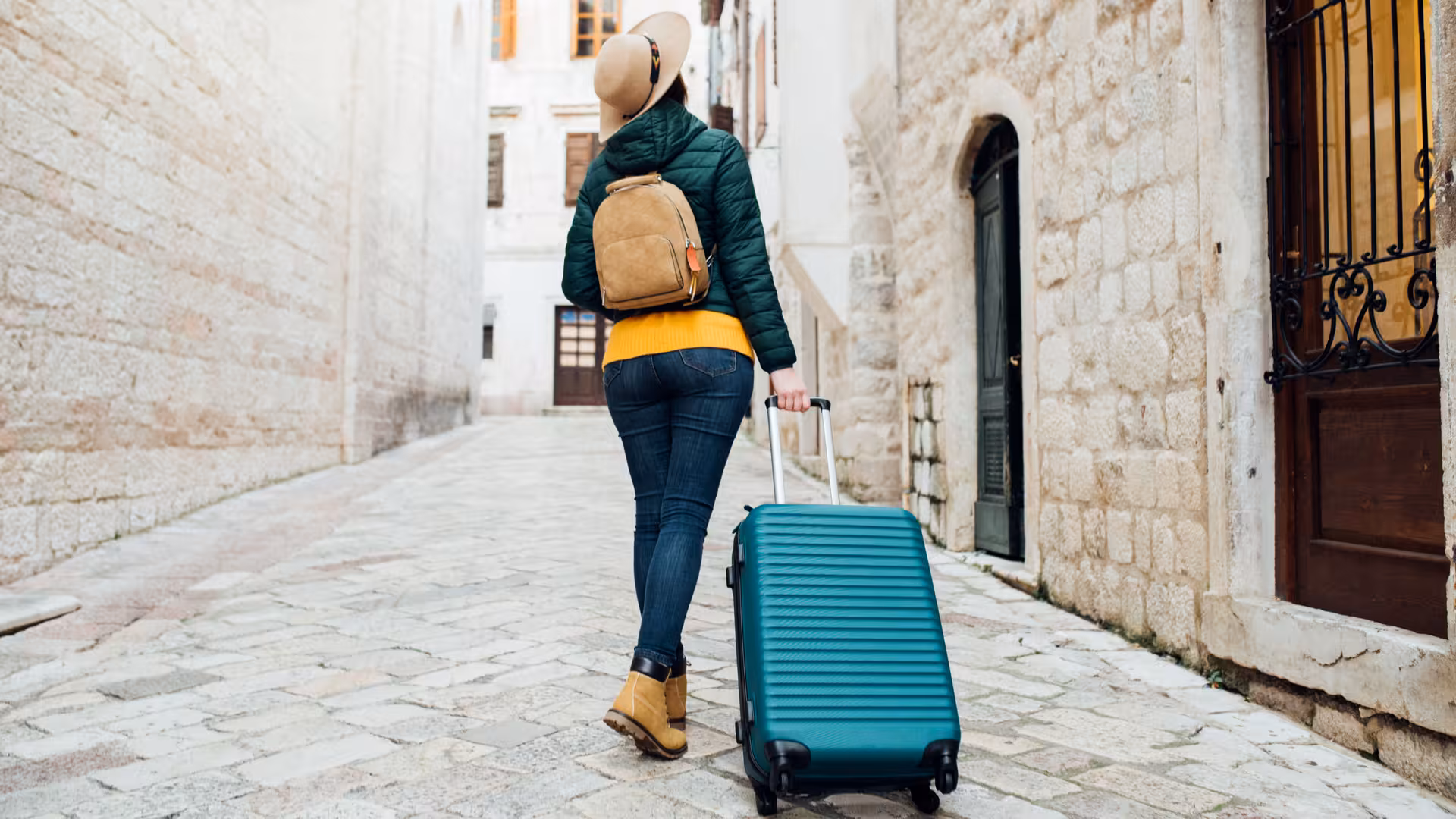 Traveler pulling suitcase for hassle-free luggage storage near London Kings Cross and Euston stations